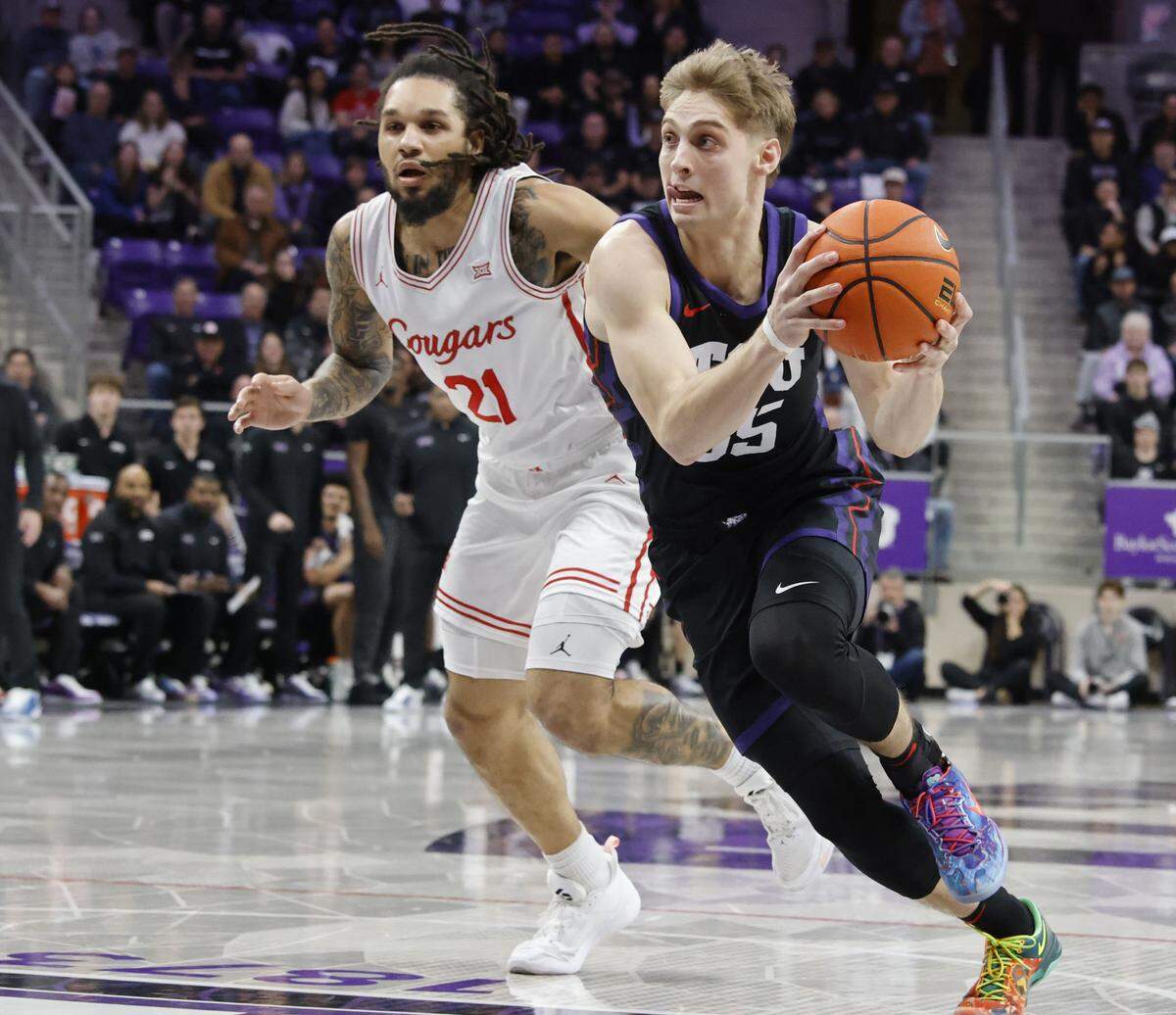 TCU guard Tanner Toolson (55) drives against Houston guard Emanuel Sharp (21) during the first half of a NCAA basketball game between the University of Houston and TCU at Schollmaier Arena in Fort Worth, Texas, Wednesday Jan. 26, 2026