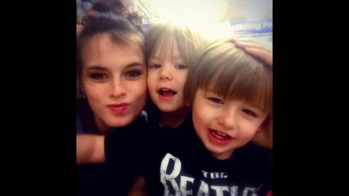 Marissa Grimes is pictured in a family photo with two of her children. A family spokesperson said the criminal justice system failed Marissa, who police say was killed by a man after he was released from jail for abusing her.