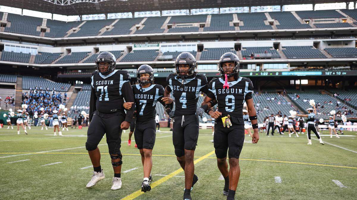 Arlington Seguin team captains walk to midfield before a district game between Arlington Seguin and Burleson at Choctaw Stadium in Arlington, Texas on Sept. 11, 2025.
