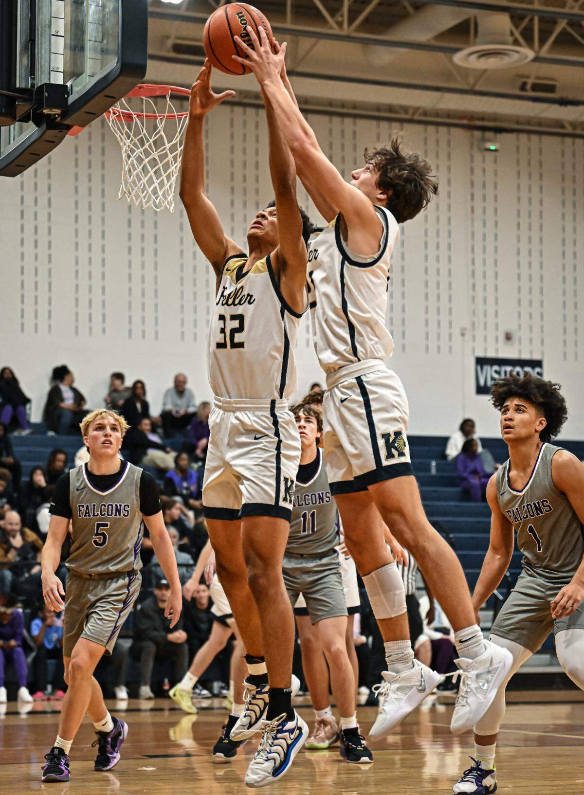 Keller’s Cash Erdmann (21), right, and Seth Turnbull (32), left, battle for a rebound against Keller Timber Creek in a District 4-6A boys basketball game on Tuesday, January 28, 2025 at Keller High School in Keller, Texas.