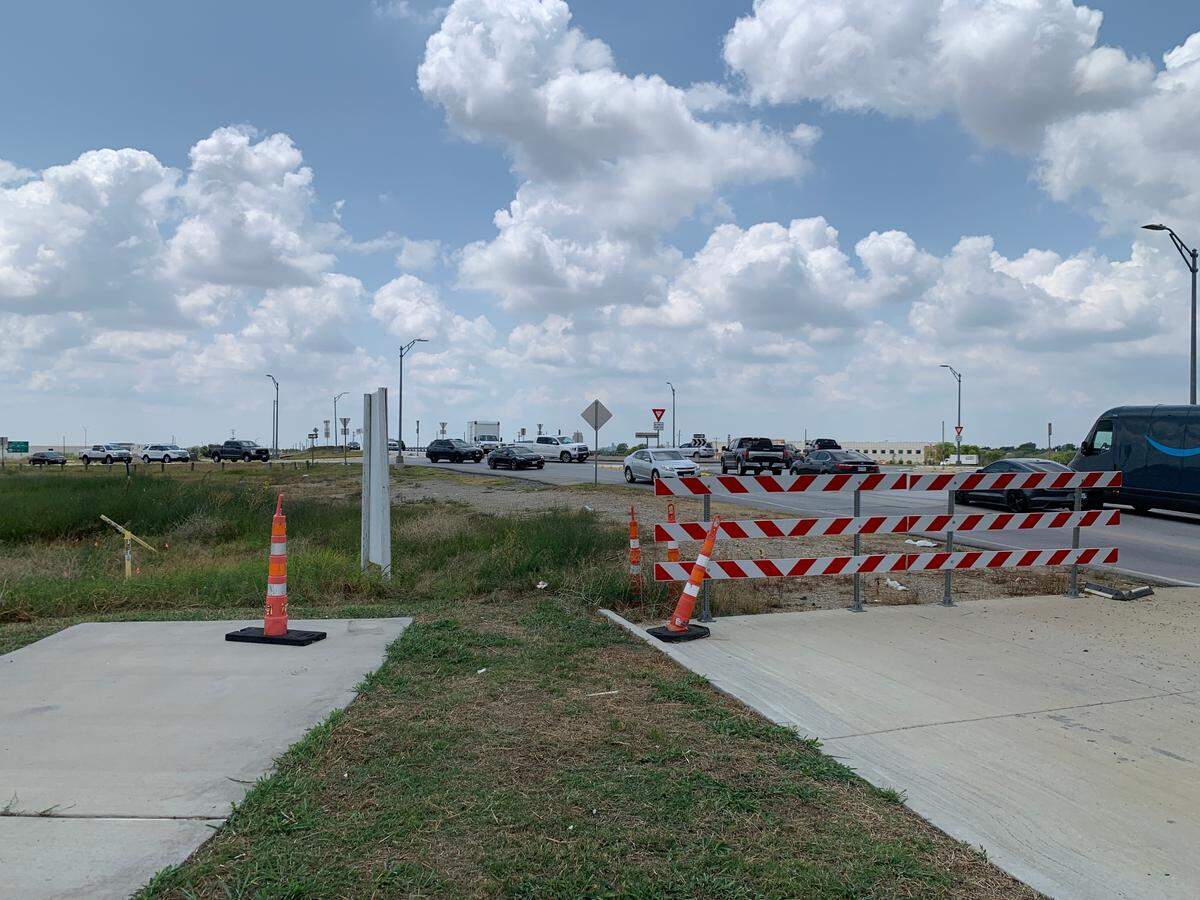 Vehicles maneuver around a tight roundabout linking Harmon Road to US 287 frontage roads. The tangle of tarmac is part of the first phase of renovations TxDOT plans to undertake as a part of its $227 million overhaul of the freeway.