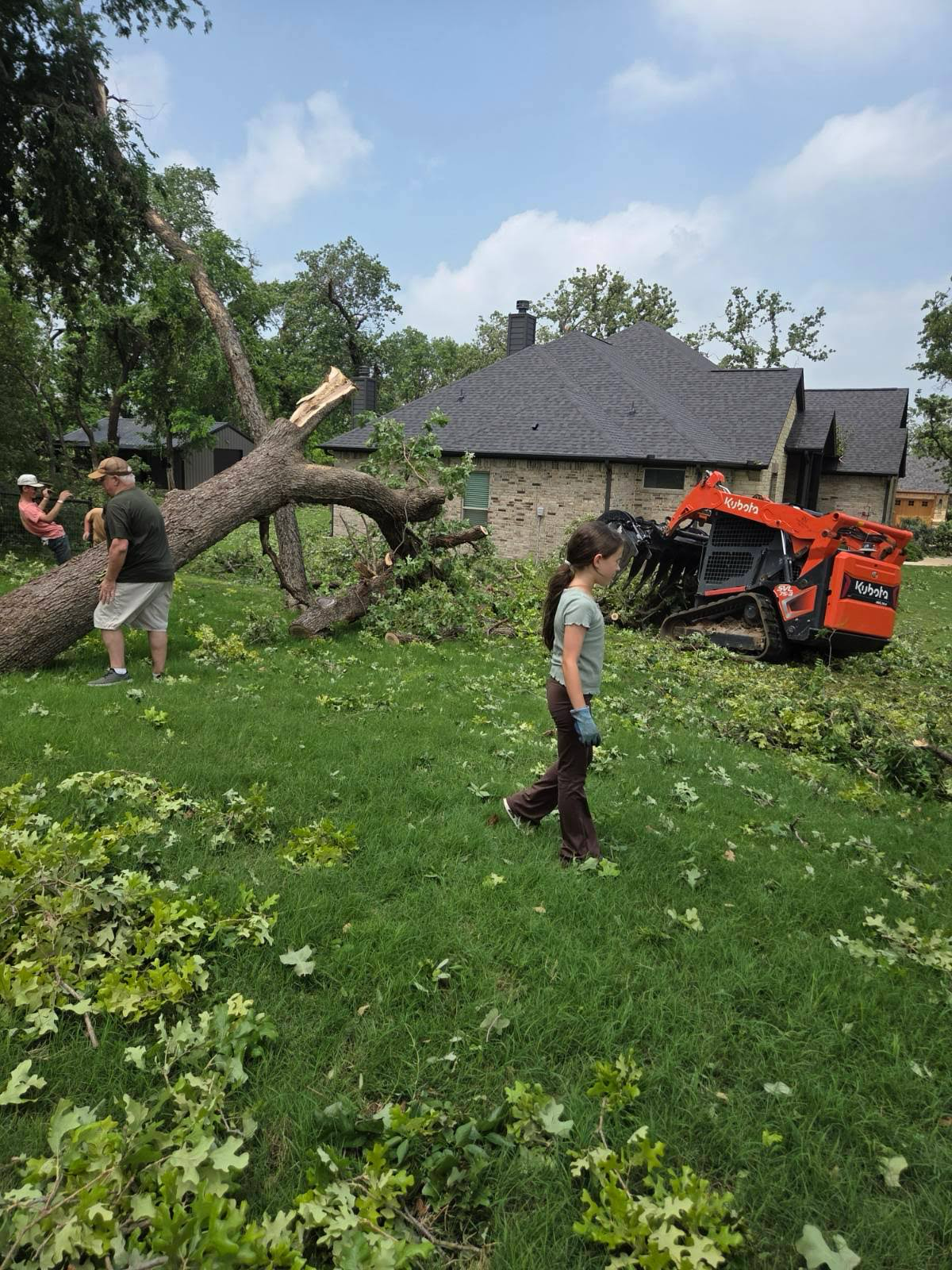 Residents clean up storm damage west of Springtown, Texas, on Sunday, April 26, 2026.