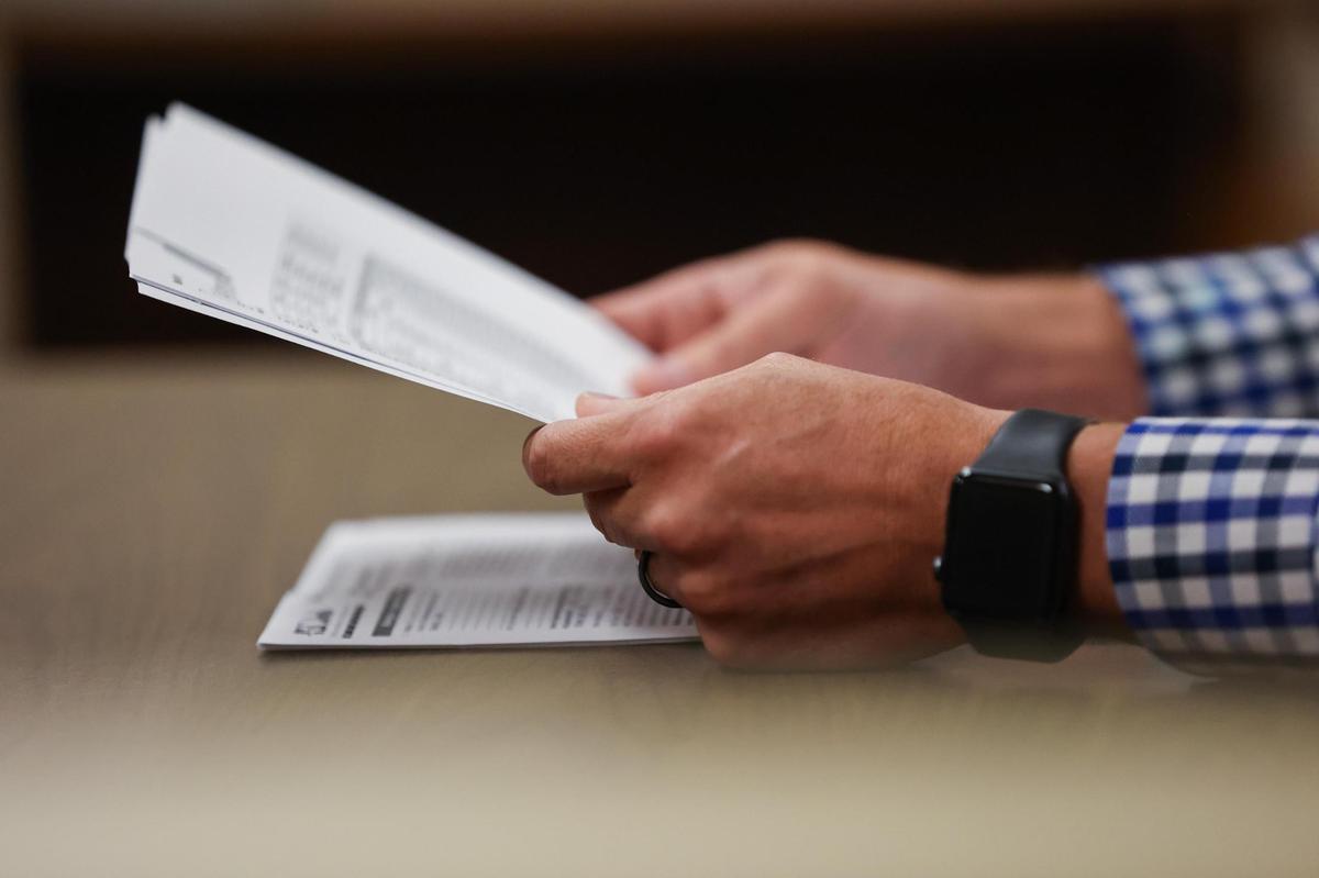 Texas eviction courts have seen increasing numbers of landlord/tenant filings in recent weeks. In this Nov. 10, 2021, photo, a plaintiff holds documents during an eviction court hearing at Judge Sergio De Leon’s court in downtown Fort Worth.