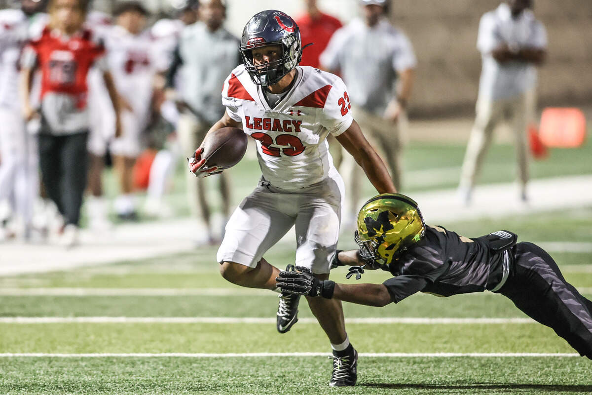 Mansfield Legacy running back J-Uan Harrison Jr. runs past a Mansfield defender in Friday’s game at Vernon Newsom Stadium. Special to the Star-Telegram / Tom Marvin