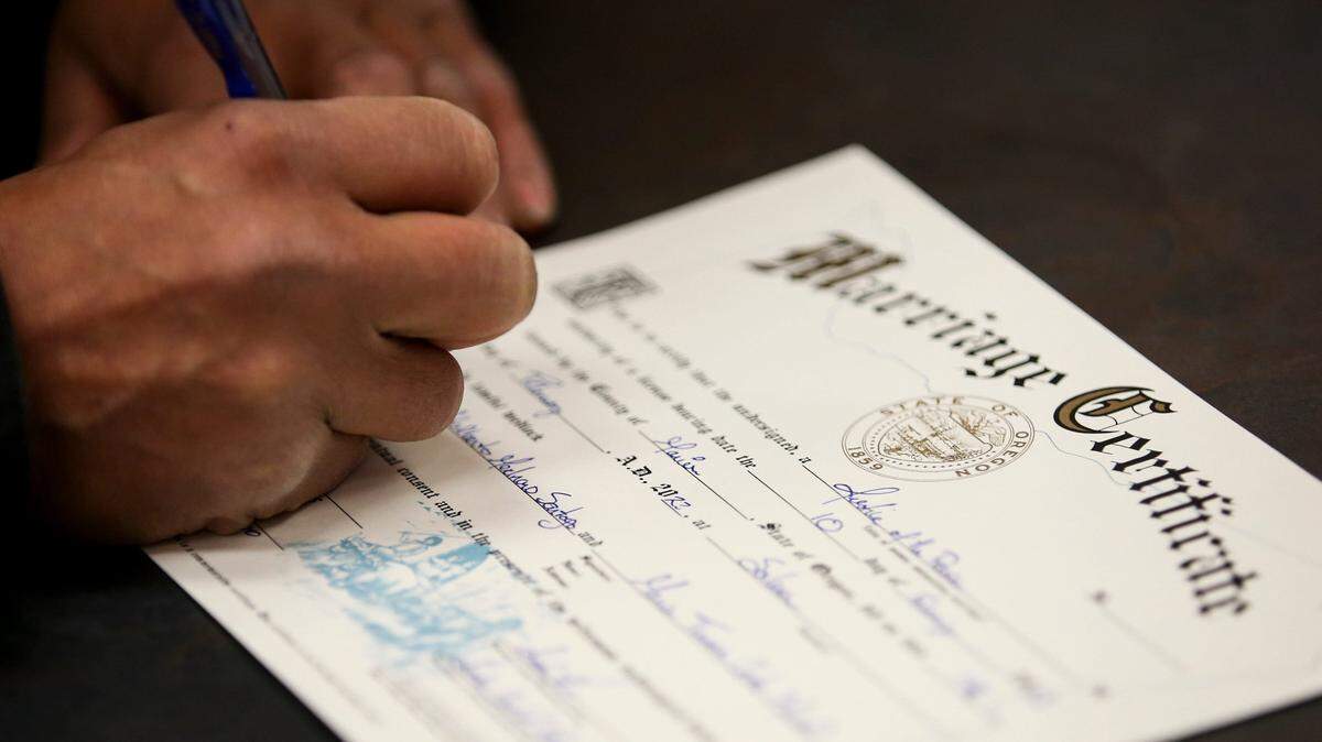 Manuel Medrano Santoyo and Maria Cortes Maciel sign their marriage certificate on Tuesday, Feb. 14, 2023 at Marion County Justice Court in Salem, Ore. Justice of the Peace Justin Kidd officiated weddings in Spanish and English all day to celebrate Valentine’s Day. Valentinesweddings
