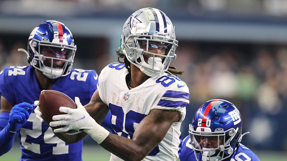 Dallas Cowboys wide receiver CeeDee Lamb pulls in a pass for a second quarter touchdown while being defended by New York Giants cornerback James Bradberry, 24, and cornerback Julian Love Sunday, October 10, 2021, at AT&T Stadium.