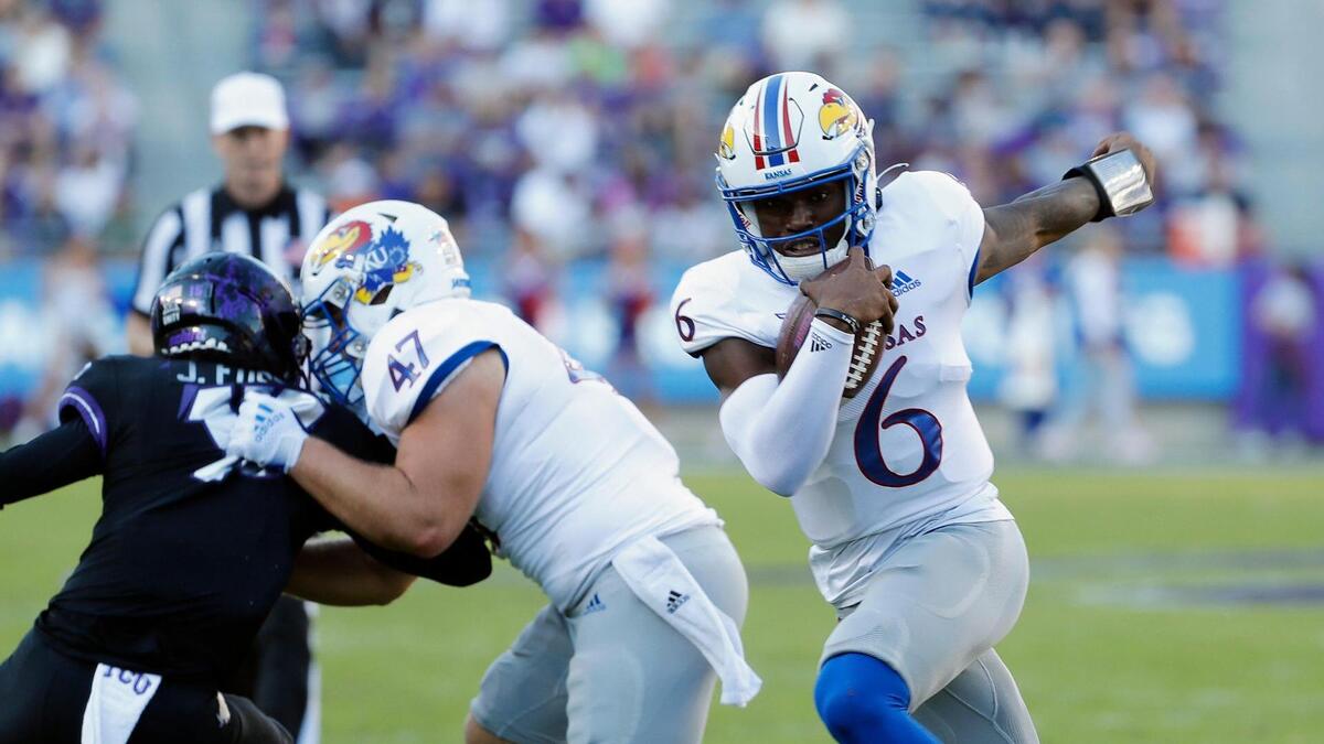 Kansas quarterback Jalon Daniels (6) follows his blocker full back Jared Casey (47) in a NCAA football game at Amon G. Carter Stadium in Fort Worth, Texas, Saturday Nov. 20, 2021. Daniels is even better this season and leads Kansas in rushing.