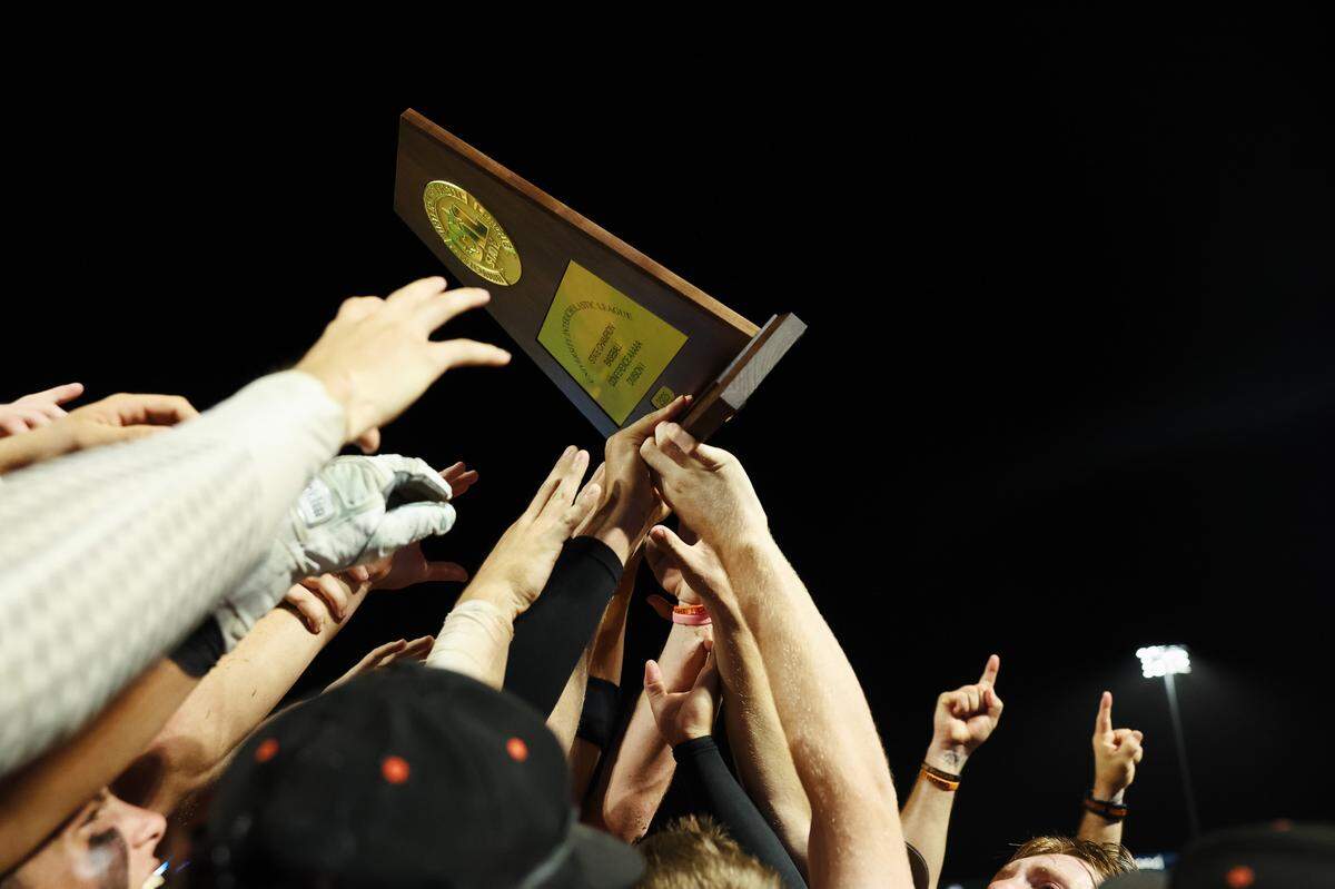 Aledo players hoist the championship trophy in the air in celebration after the Class 5A Division I playoffs state championship game at Dell Diamond Stadium on Friday, June 6, 2025.