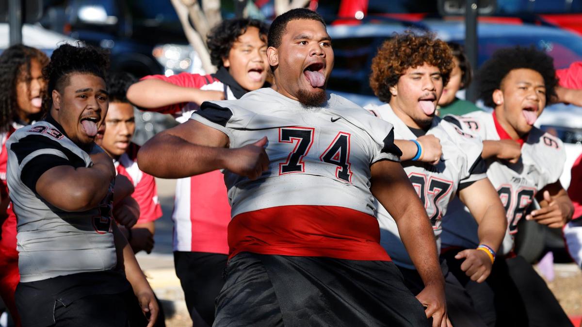Trinity Trojan offensive guard Phillip Tuiuipulotu leads teammates in the Tongan Sipi Tau war dance during a reception Monday at the Texas Star Golf Course in Euless.