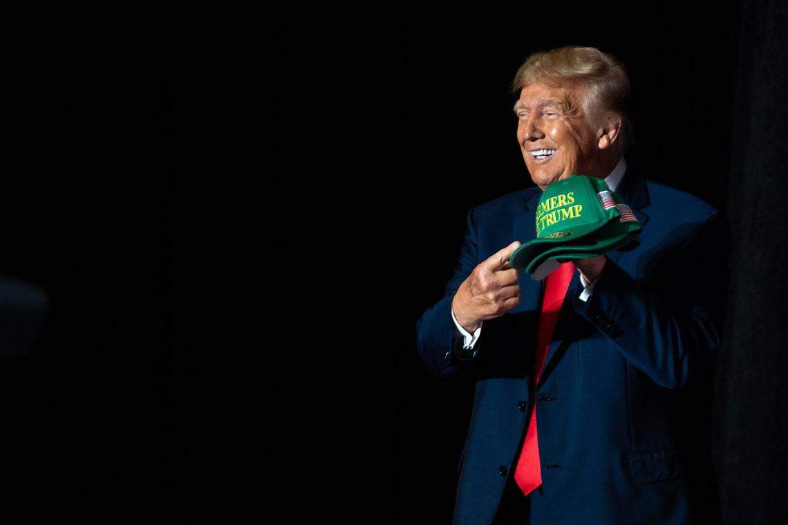 Former President Donald Trump holds up a Farmers for Trump hat during a campaign event, on Friday, July 7, 2023, at the Mid-America Center, in Council Bluffs.
