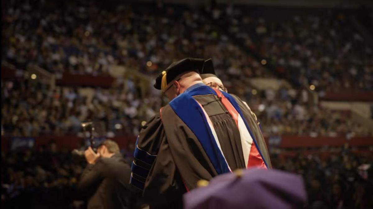 TCC graduate Mackenzie Sutton embraces her adoptive father, TCC professor David Sutton, at TCC’s graduation ceremony in Fort Worth on May 15, 2026.