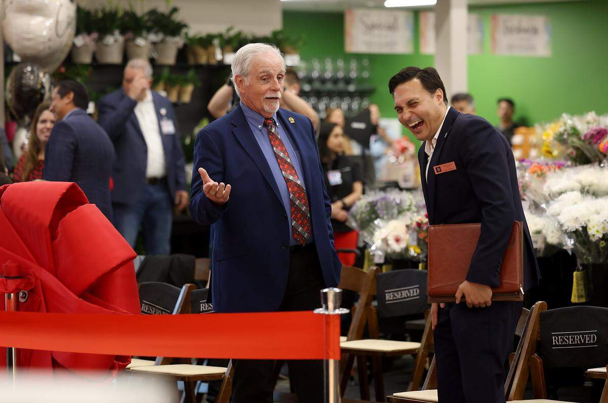 Euless Mayor Tim Stinneford, left, and Bedford Mayor Dan Cogan laugh together at the ribbon-cutting for the new Mid-Cities H-E-B on Tuesday, May 19, 2026. The grocery store, located at 105 Rio Grande Boulevard, sits in both Euless and Bedford.