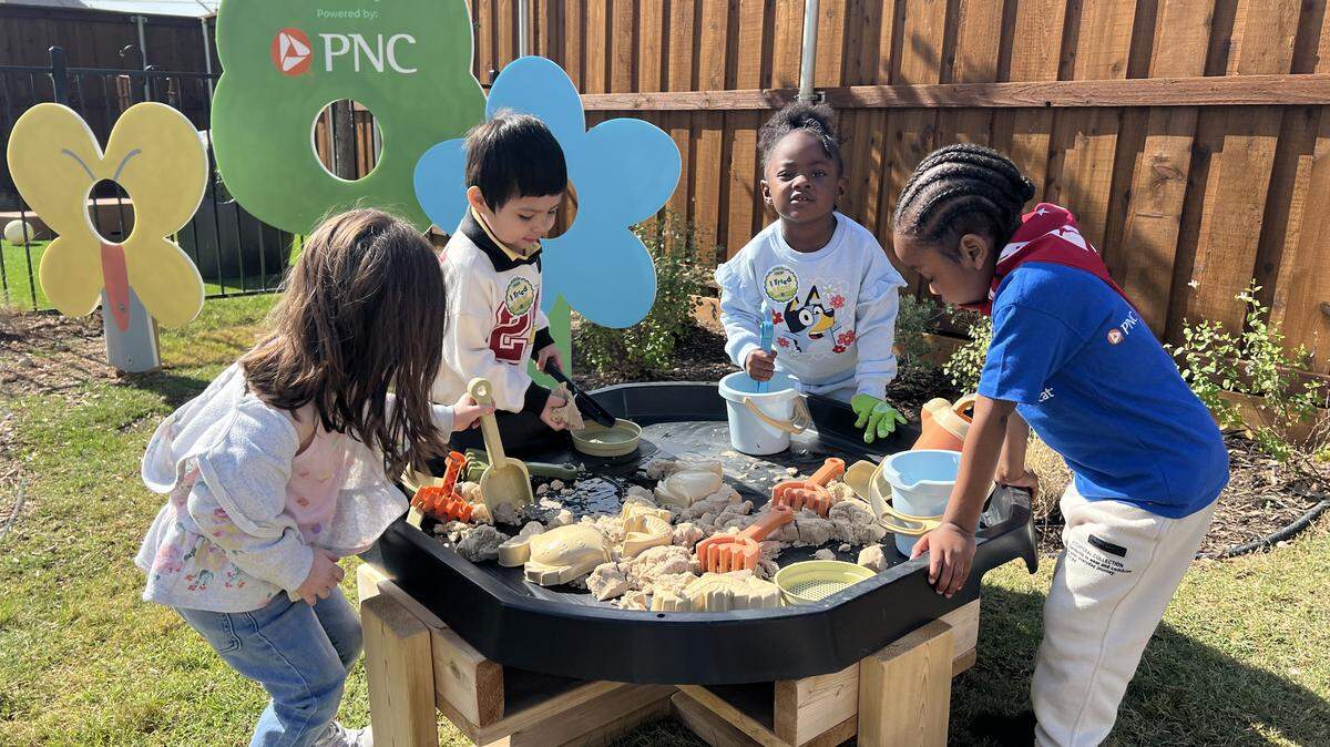 A group of 3- and 4-year-old students play with sand and water at a sensory table in the outdoor learning area of the Child Care Studio at Rise in Fort Worth’s Las Vegas Trail Neighborhood on May 7, 2026.