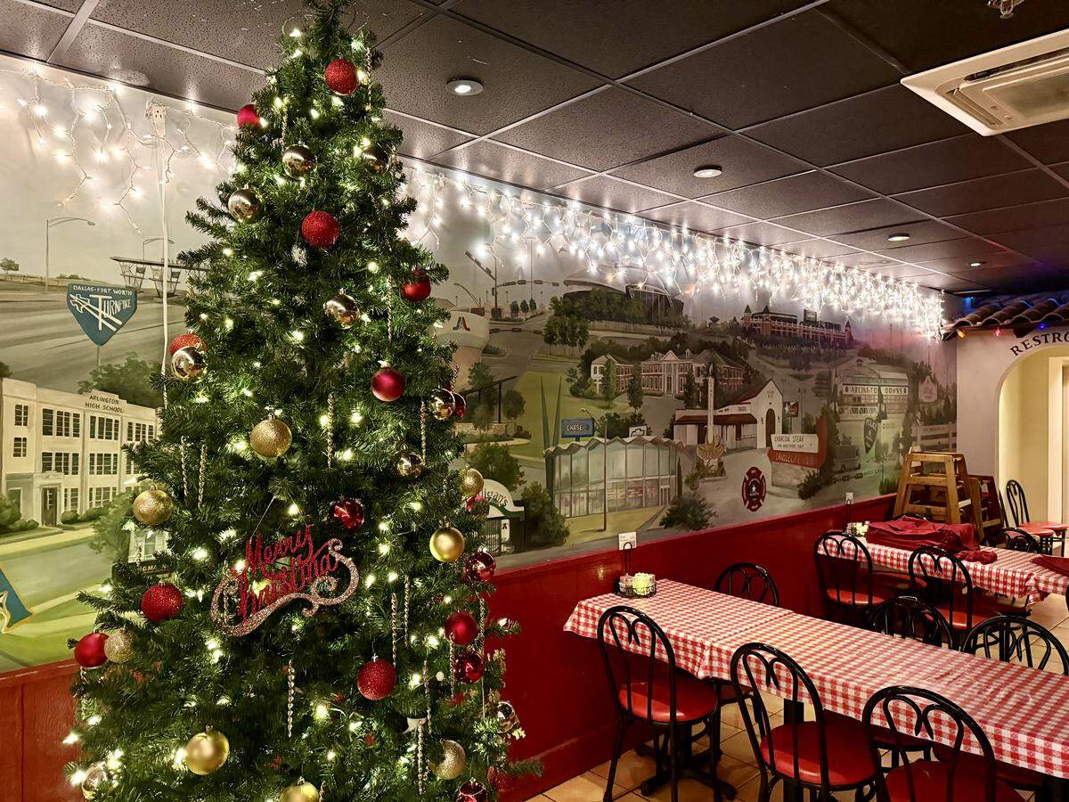 Christmas decorations and a mural of old Arlington at the Candlelite Inn restaurant, open since 1957 on East Division Street in Arlington, Texas. Seen Dec. 6, 2025.