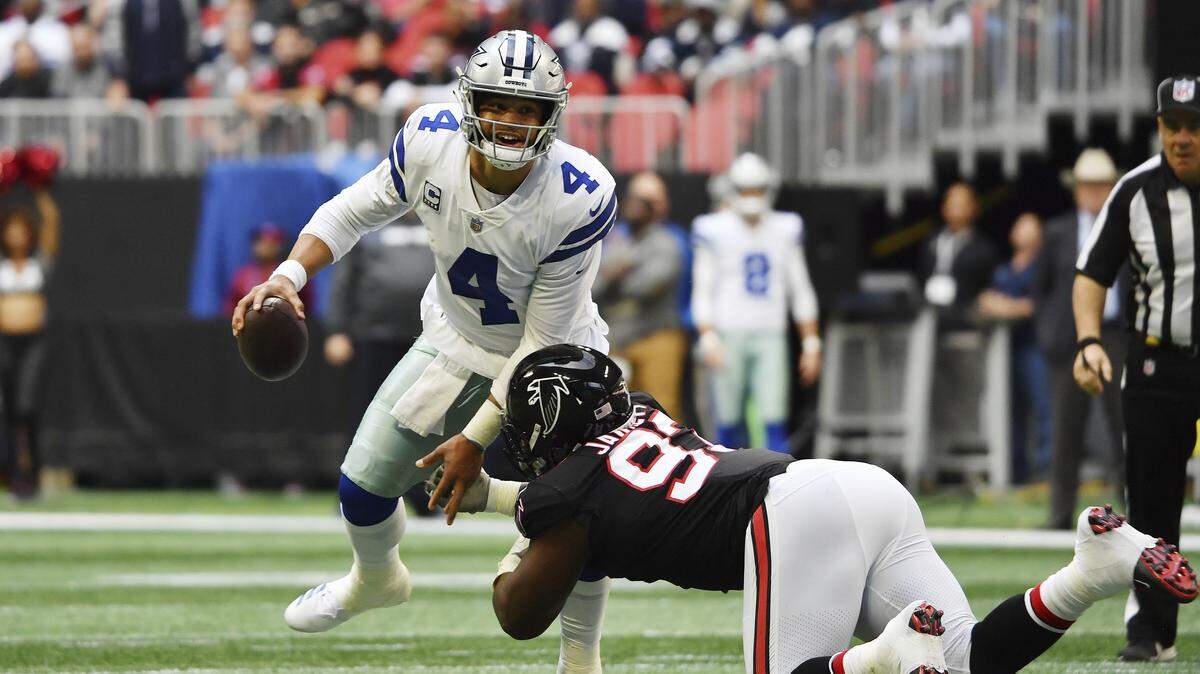 Dallas Cowboys quarterback Dak Prescott (4) throws the ball against Atlanta Falcons defensive tackle Grady Jarrett (97) during the first half of an NFL football game, Sunday, Nov. 18, 2018, in Atlanta.