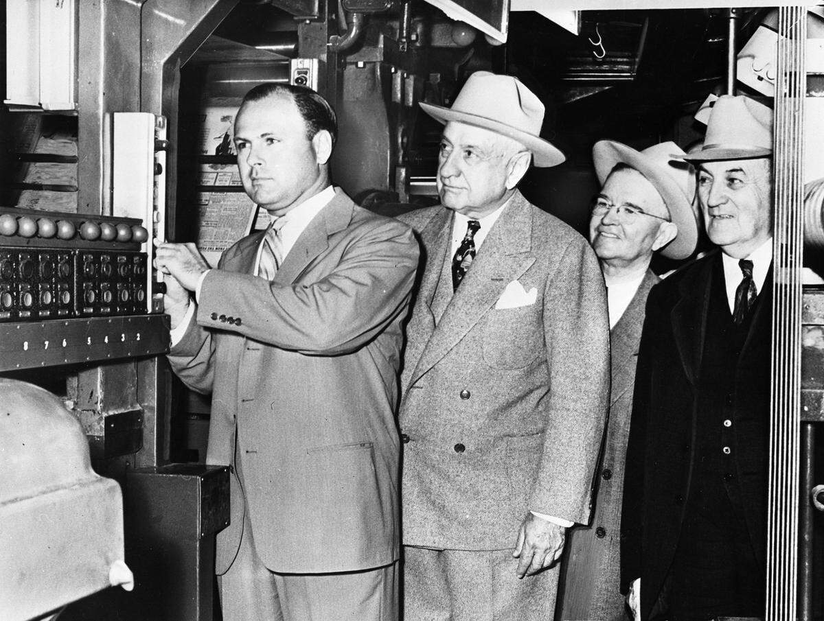 Amon Carter Jr., left, pushes the button to start the Fort Worth Star-Telegram’s new 10-unit Gross Headliner press on April 17, 1949. Next to him are Amon Carter Sr.; Harold V. Hough, circulation manager; and J.M. North, editor.