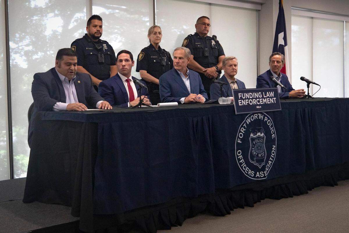 President of the Austin Police Assocation Thomas Villarreal, Fort Worth Police Officers Association President Manny Ramirez, Texas governor Greg Abbott, Rep. Phil King and Sen. Kelly Hancock sit on a panel during a press conference at the FWPOA on Wednesday, Sept. 14, 2022.