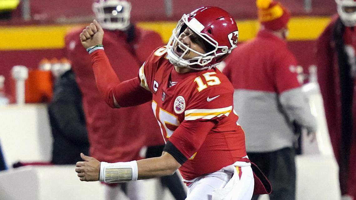 FILE - In this Sunday, Jan. 24, 2021, file photo, Kansas City Chiefs quarterback Patrick Mahomes celebrates after throwing a 5-yard touchdown pass to tight end Travis Kelce during the second half of the AFC championship NFL football game against the Buffalo Bills in Kansas City, Mo. The Super Bowl matchup features the most accomplished quarterback ever to play the game who is still thriving at age 43 in Brady against the young gun who is rewriting record books at age 25. (AP Photo/Jeff Roberson, File)