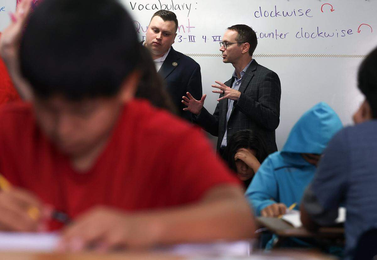 State Education Commissioner Mike Morath, right, talks with State Board of Education Member Brandon Hall while touring William James Middle School on Thursday, Aug. 28, 2025, in Fort Worth.
