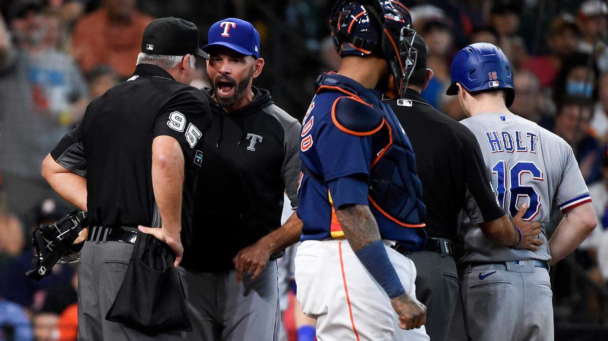 Texas Rangers manager Chris Woodward, second and from left, argues with home plate umpire Tim Timmons after Brock Holt, right, and Woodward were ejected for arguing a called third strike in the fourth inning Sunday at Minute Maid Park. The Houston Astros won 3-1 to sweep the series as the Rangers’ losing streak hit 12 games, tied for second-longest in club history.