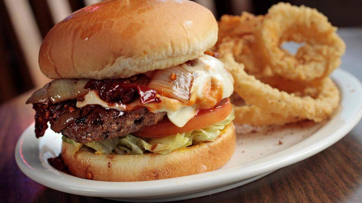Popular entrees at Fred’s Texas Cafe in Fort Worth include the Diablo Burger with onion rings.