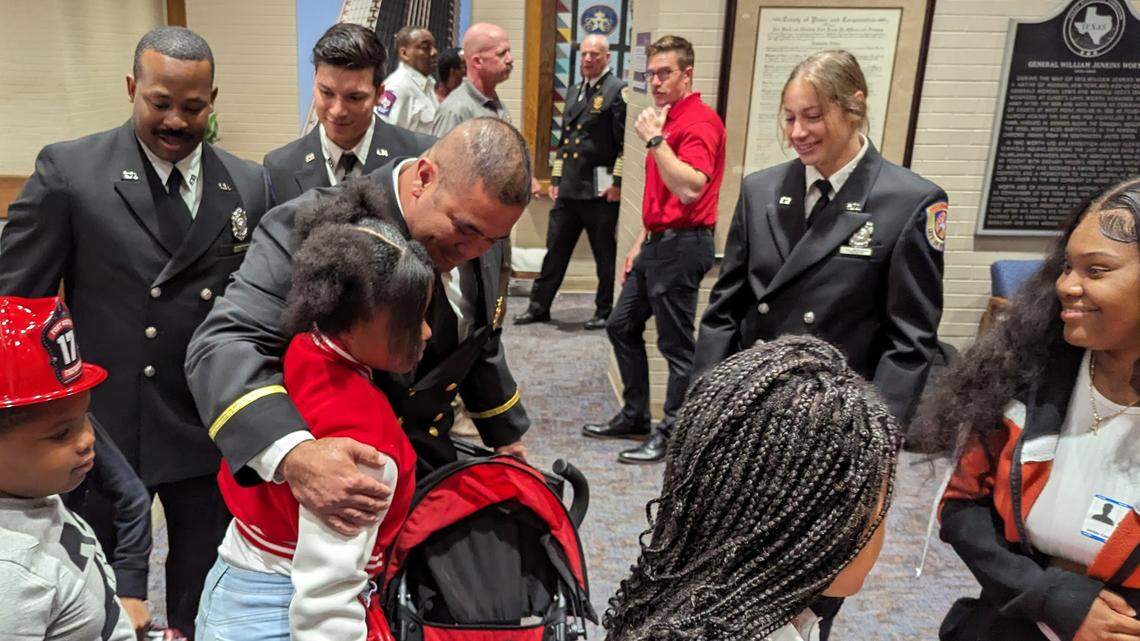 A man hugs a girl surrounded by family. 
