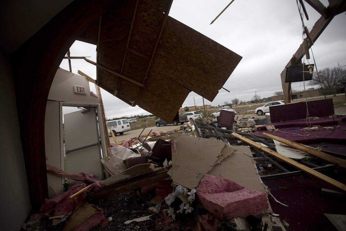 Volunteers secure the Ovilla Road Church of the Nazarene in Glenn Heights, south of Dallas, on Monday, Dec. 28, 2015. The church was damaged by the tornado on Saturday, Dec. 26, 2015.