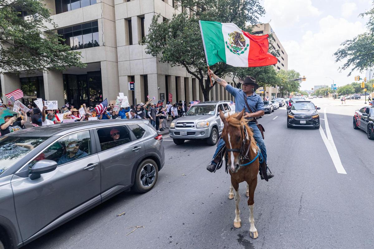 Community members rally during the “No Kings Day” protest in downtown Fort Worth on June 14, 2025.
