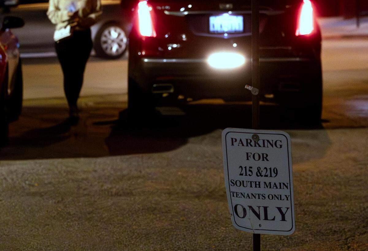 A sign notifies drivers that a parking lot on South Main is limited to nearby tenants only.