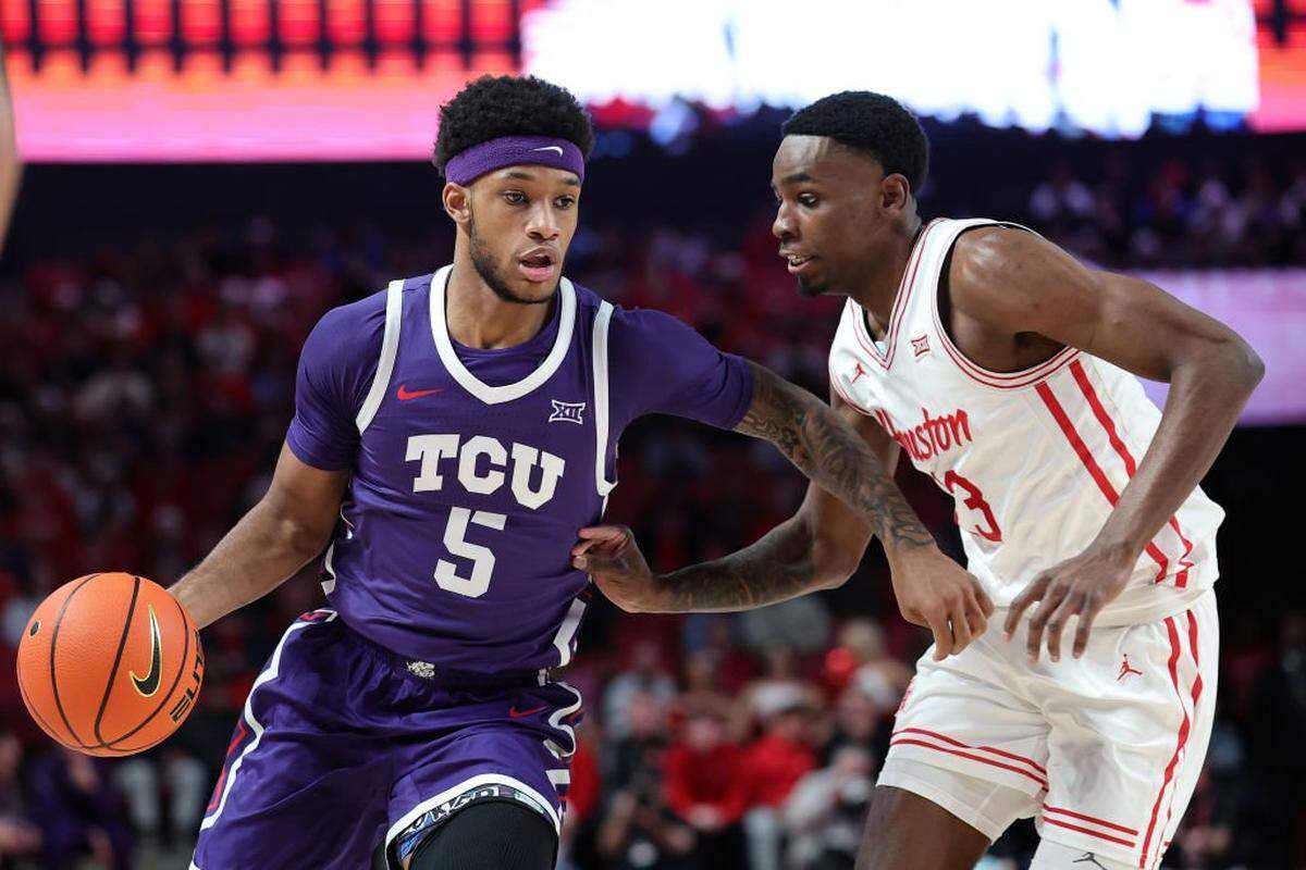 HOUSTON, TEXAS - JANUARY 06: Micah Robinson #5 of the TCU Horned Frogs works against Terrance Arceneaux #23 of the Houston Cougars during the first half at Fertitta Center on January 06, 2025 in Houston, Texas. (Photo by Alex Slitz/Getty Images)