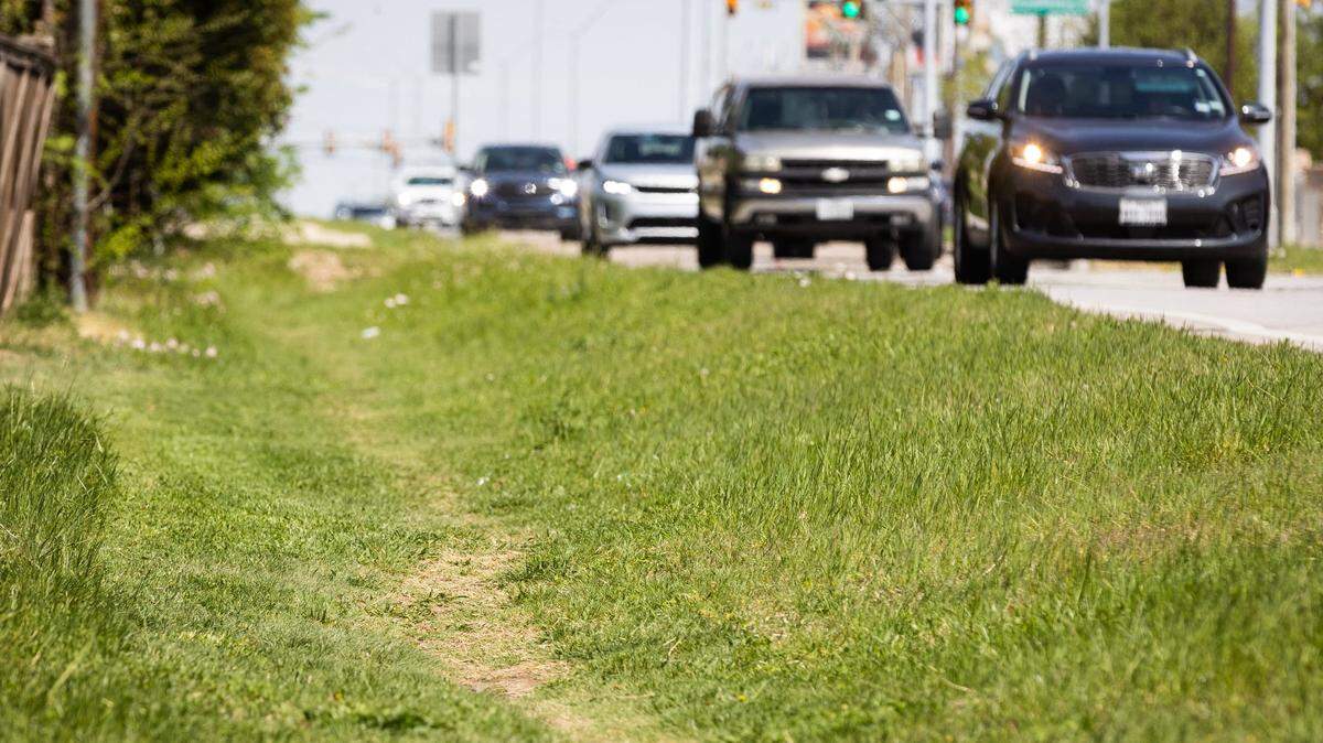 A path in the grass is used by pedestrians along West Bailey Boswell Road near Wind River Drive in Fort Worth.