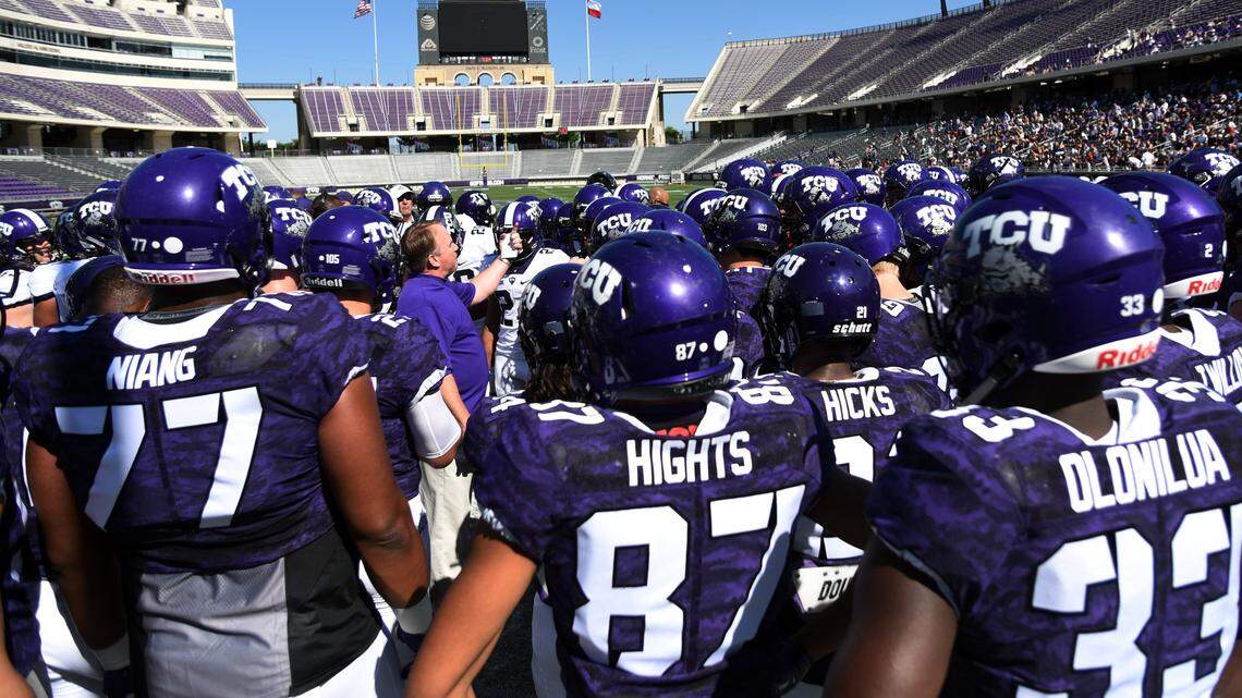 TCU coach Gary Patterson is surrounded by his team before the 2017 spring game at Amon G. Carter Stadium.