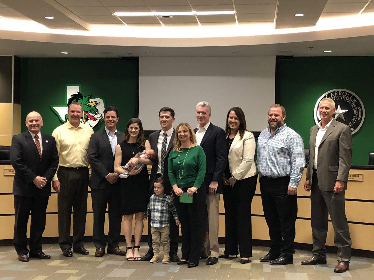 Riley Dodge and family photographed with Carroll ISD board of trustees on Monday night.