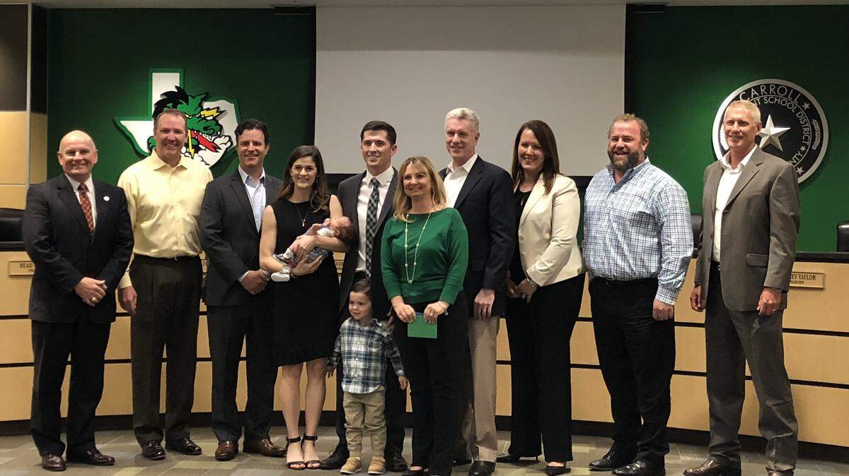 Riley Dodge and family photographed with Carroll ISD board of trustees on Monday night.