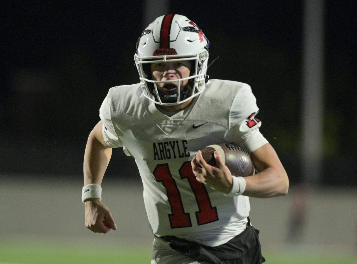 Argyle quarterback Maguire Gasperson (11) runs towards the end zone during the Class 5A Division II Region I playoff game against Lovejoy High School at Prosper ISD Children’s Health Stadium in Prosper, Texas on Friday, Dec. 6, 2024.