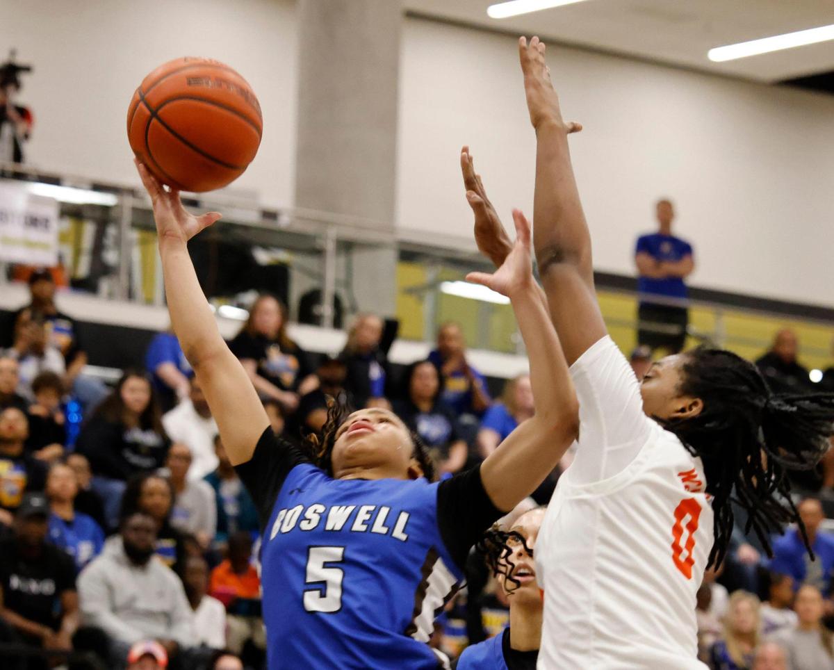 Fort Worth Boswell guard Sydney Durrah (5) right hooks one against Lancaster forward Kamoriya Davis (0) during the second half of the UIL Class 6A D2 state semifinal girls basketball game at The Colony High School in The Colony, Texas, Tuesday, Feb. 25, 2025.