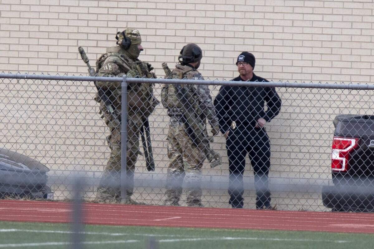 Law enforcement officials gather at a school near the Congregation Beth Israel synagogue on Saturday in Colleyville.
