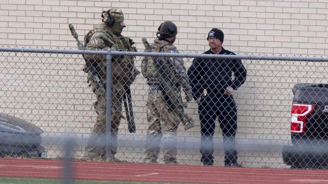 Law enforcement officials gather at a local school near the Congregation Beth Israel synagogue on Saturday, Jan. 15, in Colleyville, Texas. (AP Photo/Gareth Patterson)