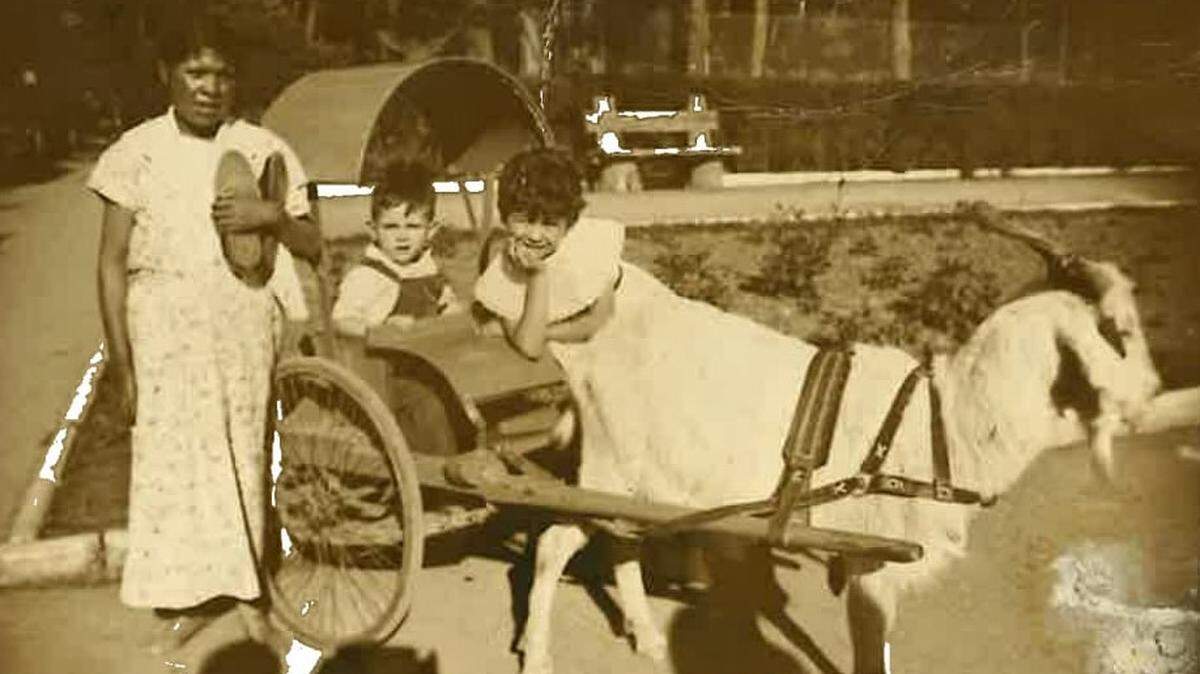 Belinda and Fernando González with maid Minerva (last name unknown) take a buggy goat ride at Chapultepec Park Zoo in Mexico City, December 1958.