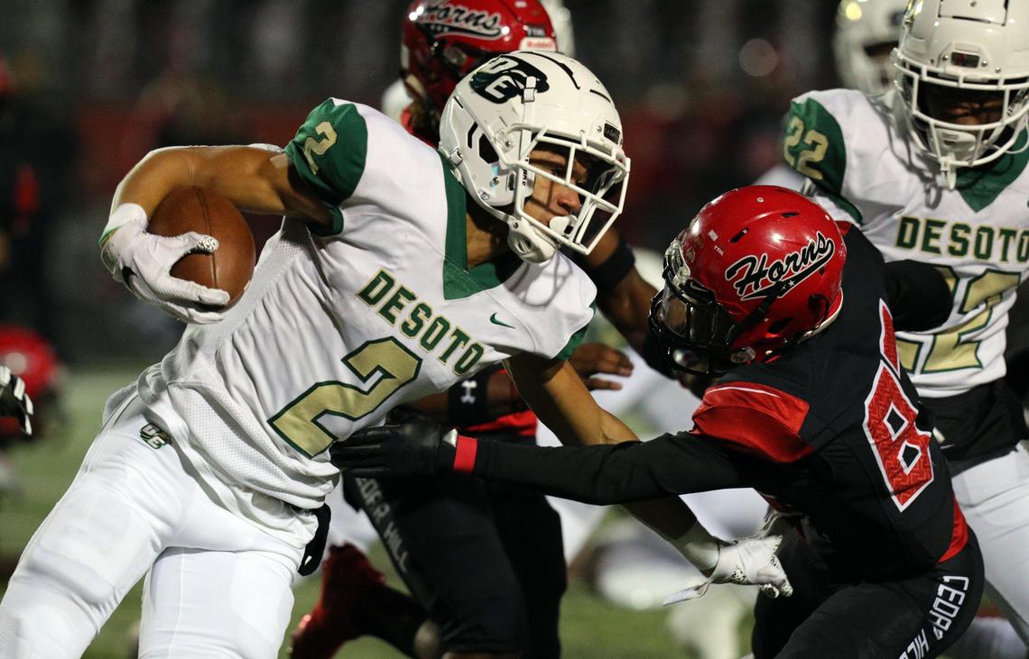 DeSoto’s Cameron Hutchings (2) tries to avoid a tackle by Cedar Hill’s Antwan Reeves (87) during a high school football game at Longhorn Stadium in Cedar Hill, Texas, Thursday, Nov. 7, 2019.