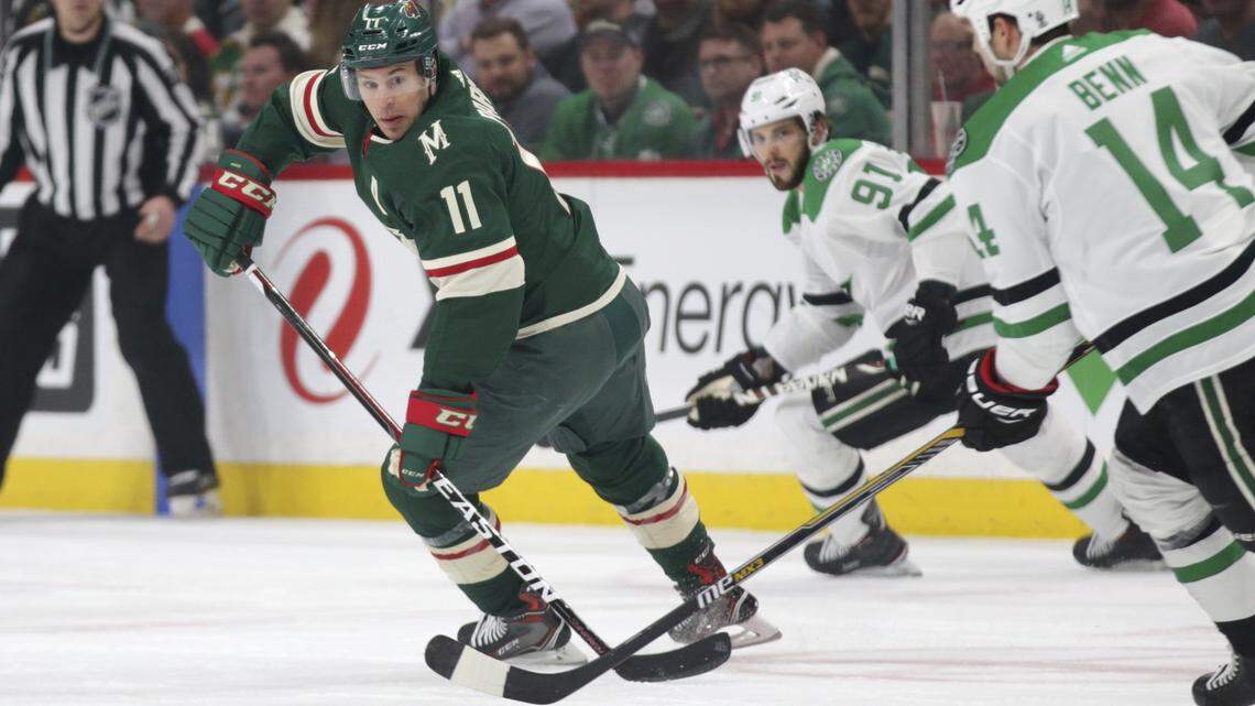 Minnesota Wild left wing Zach Parise (11) defends against Dallas Stars left wing Jamie Benn (14) and Stars center Tyler Sequin (91) during the first period of Thursday's NHL hockey game in St. Paul, Minn.