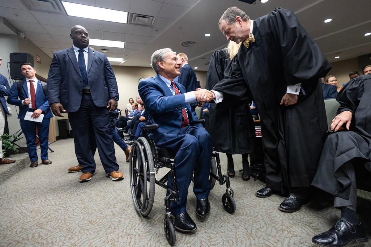 Texas Governor Greg Abbott shakes hands with newly appointed First Division Business Court judge William Whitehill following his official swearing in ceremony at the Texas A&M Law School in downtown Fort Worth on Thursday, Sept. 19, 2024.
