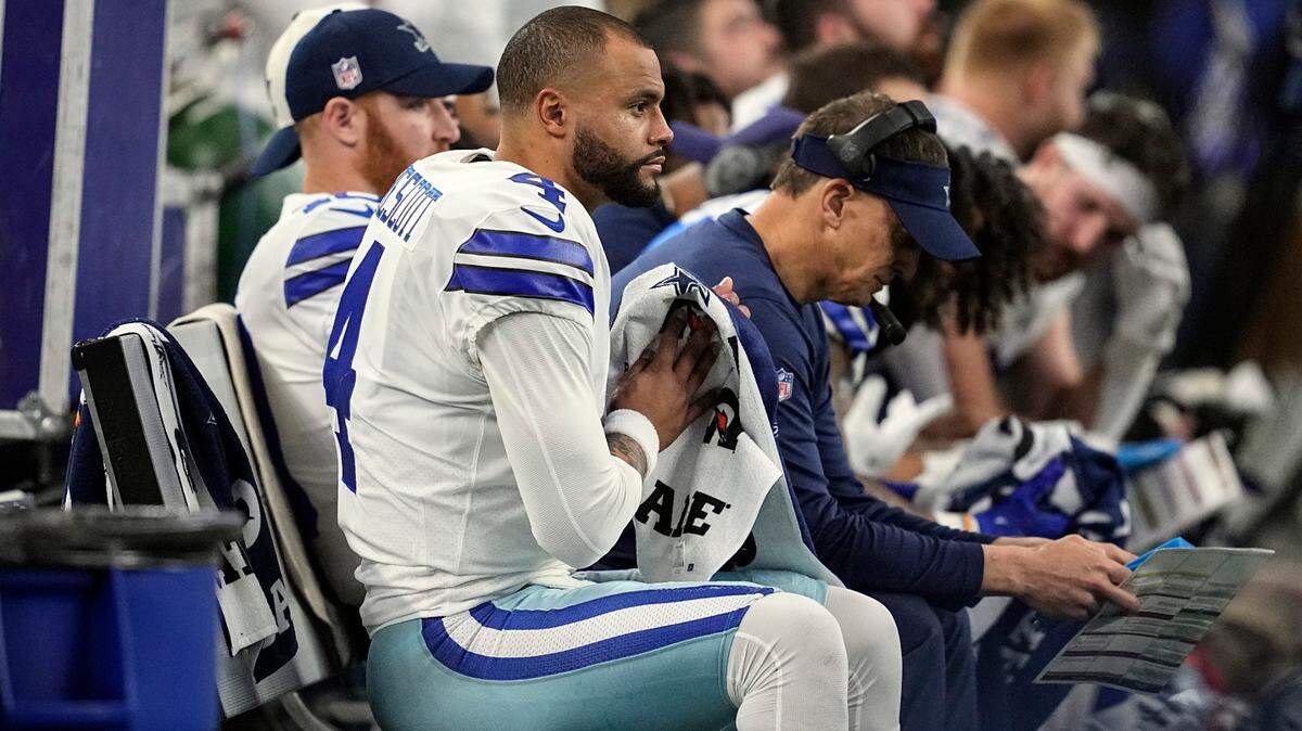 Dallas Cowboys quarterback Dak Prescott (4) sits on the bench during Sunday’s game against the Houston Texans at AT&T Stadium.