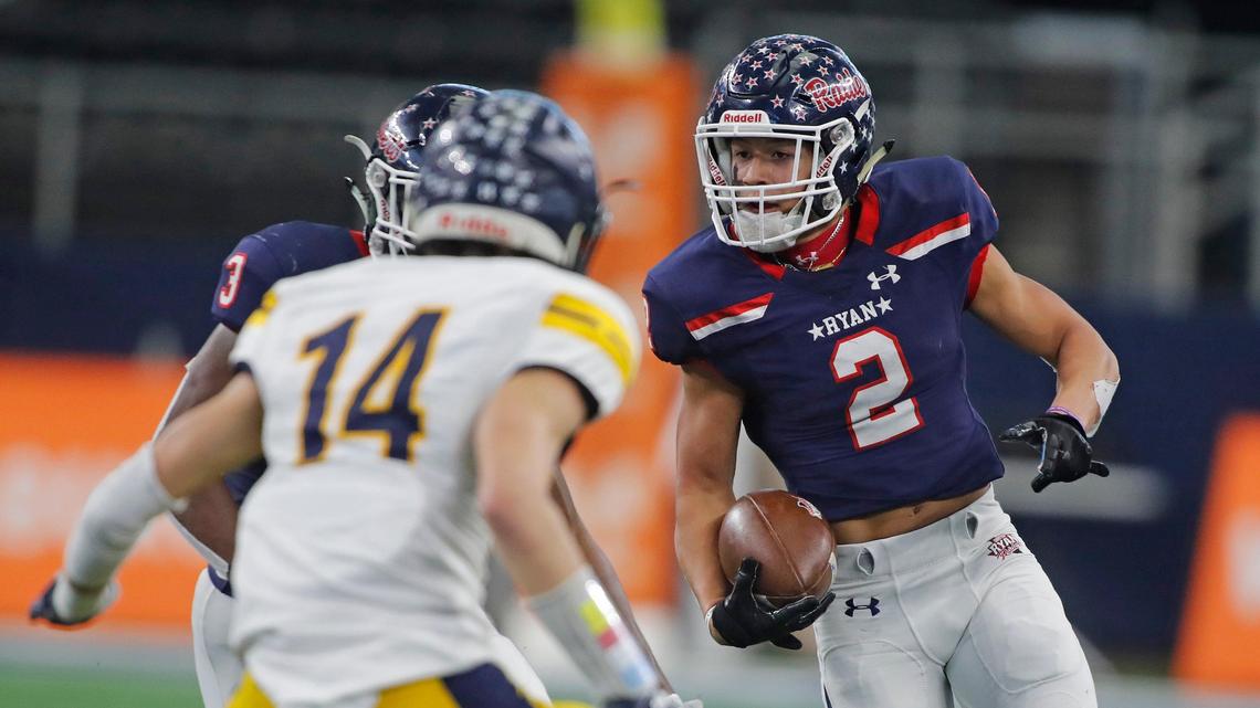 Denton Ryan wide receiver Billy Bowman Jr. (2) attempts to avoid the tackle of Highland Park defensive back Hudson Clark (14) in the second half of a high school Class 5A Division I State Semifinals football playoff game at AT&T Stadium, Arlington, Texas, Saturday, Dec. 15, 2018. Highland Park won 43-21. (Star-Telegram Bob Booth)