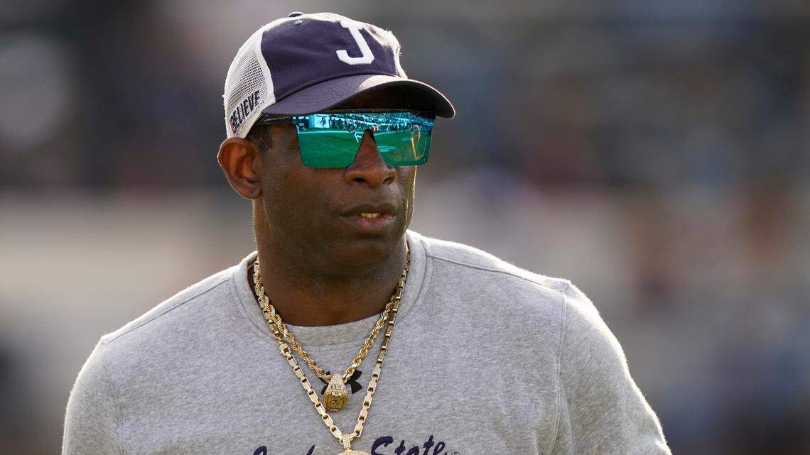 Jackson State head coach Deion Sanders surveys his players during warmups prior to the Southwestern Athletic Conference championship NCAA college football game against Southern University, Saturday, Dec. 3, 2022, in Jackson, Miss. (AP Photo/Rogelio V. Solis)