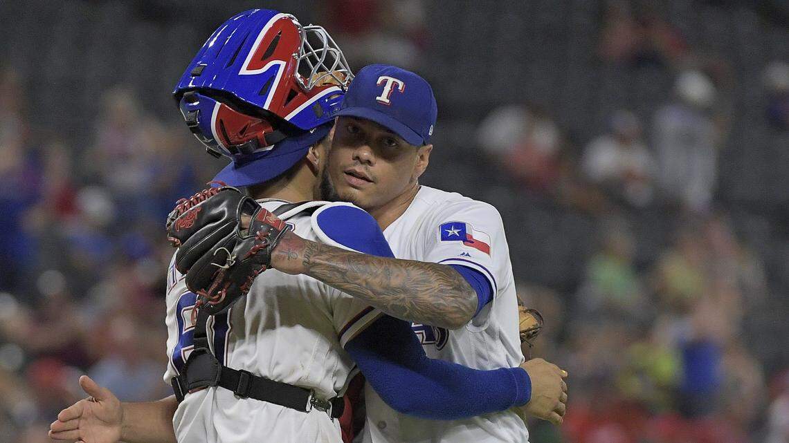 Rangers closer Keone Kela, right, hugs catcher Robinson Chirinos after  securing his 19th save in 19 chances Monday as Texas beat San Deigo 7-4 at Globe Life Park.