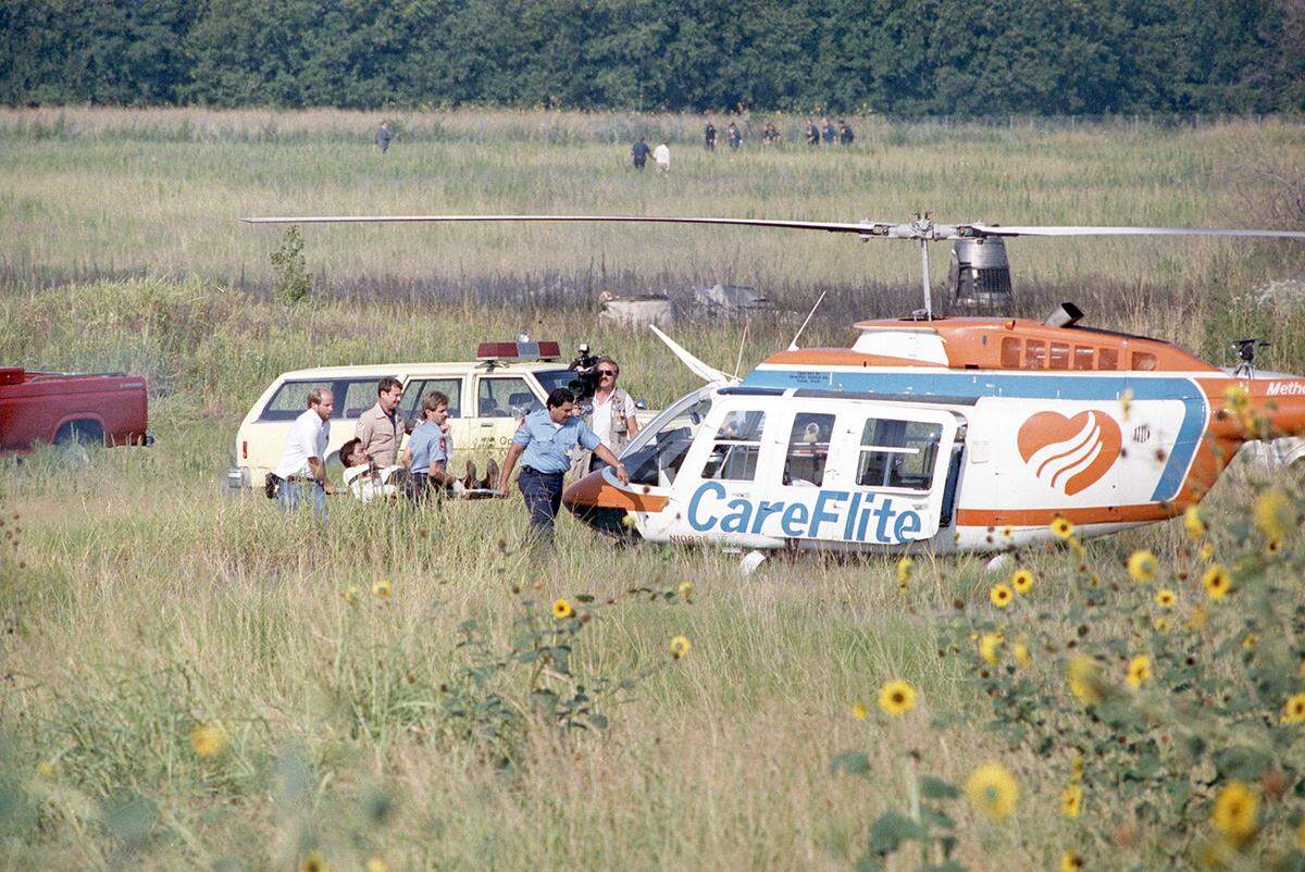 Aug. 31, 1988: Paramedics rush a conscious crash victim from Delta 1141 to a rescue CareFlite helicopter while a television reporter captures the scene. The plane crashed during takeoff at Dallas-Fort Worth International Airport.