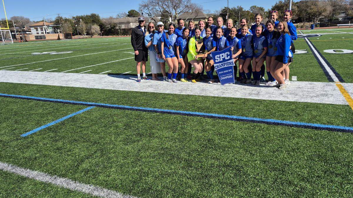 Fort Worth Trinity Valley girls soccer poses for a team picture after winning a fourth consecutive state championship Saturday at Jones Field in Dallas.