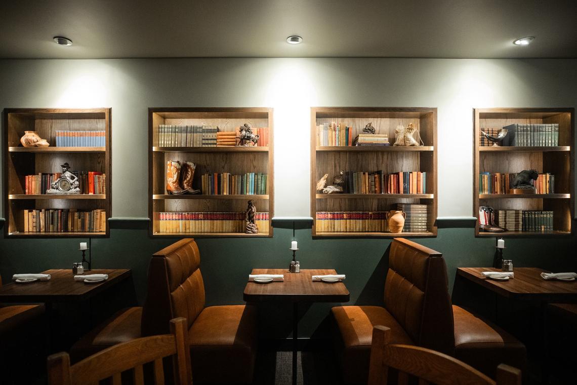 A display of western items and books by a booth on Friday, July 19 at Reata Restaurant in the Tower. Reata is known for its western theme.