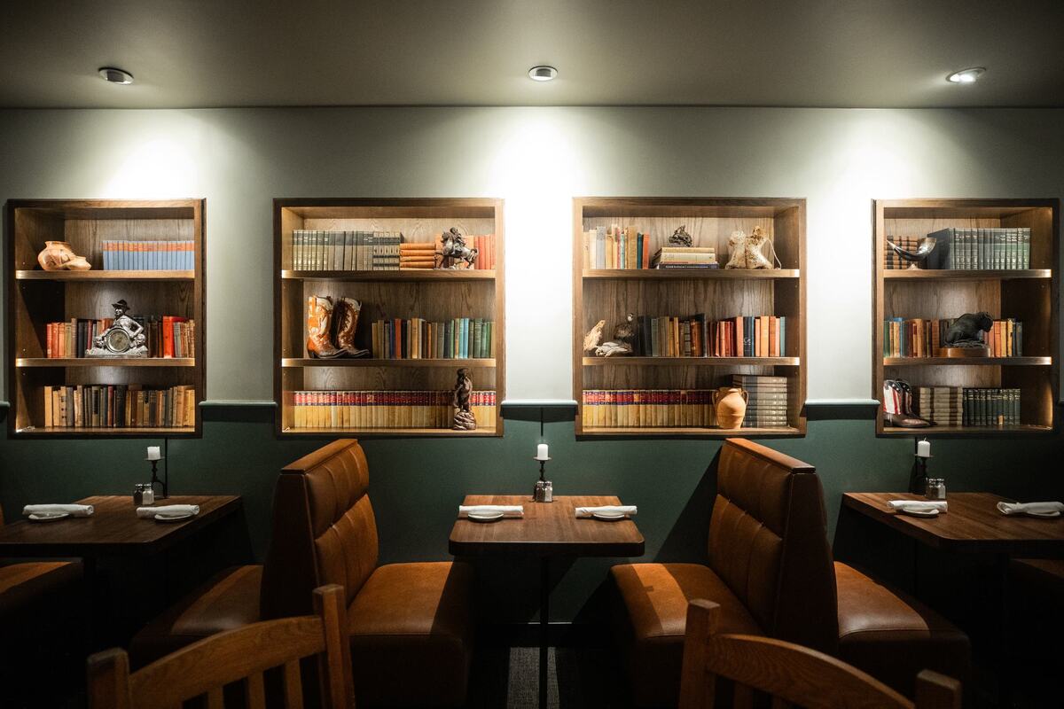 A display of western items and books by a booth on Friday, July 19 at Reata Restaurant in the Tower. Reata is known for its western theme.